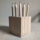 Kima Design Paperweight made from wood with holes for storing pencils